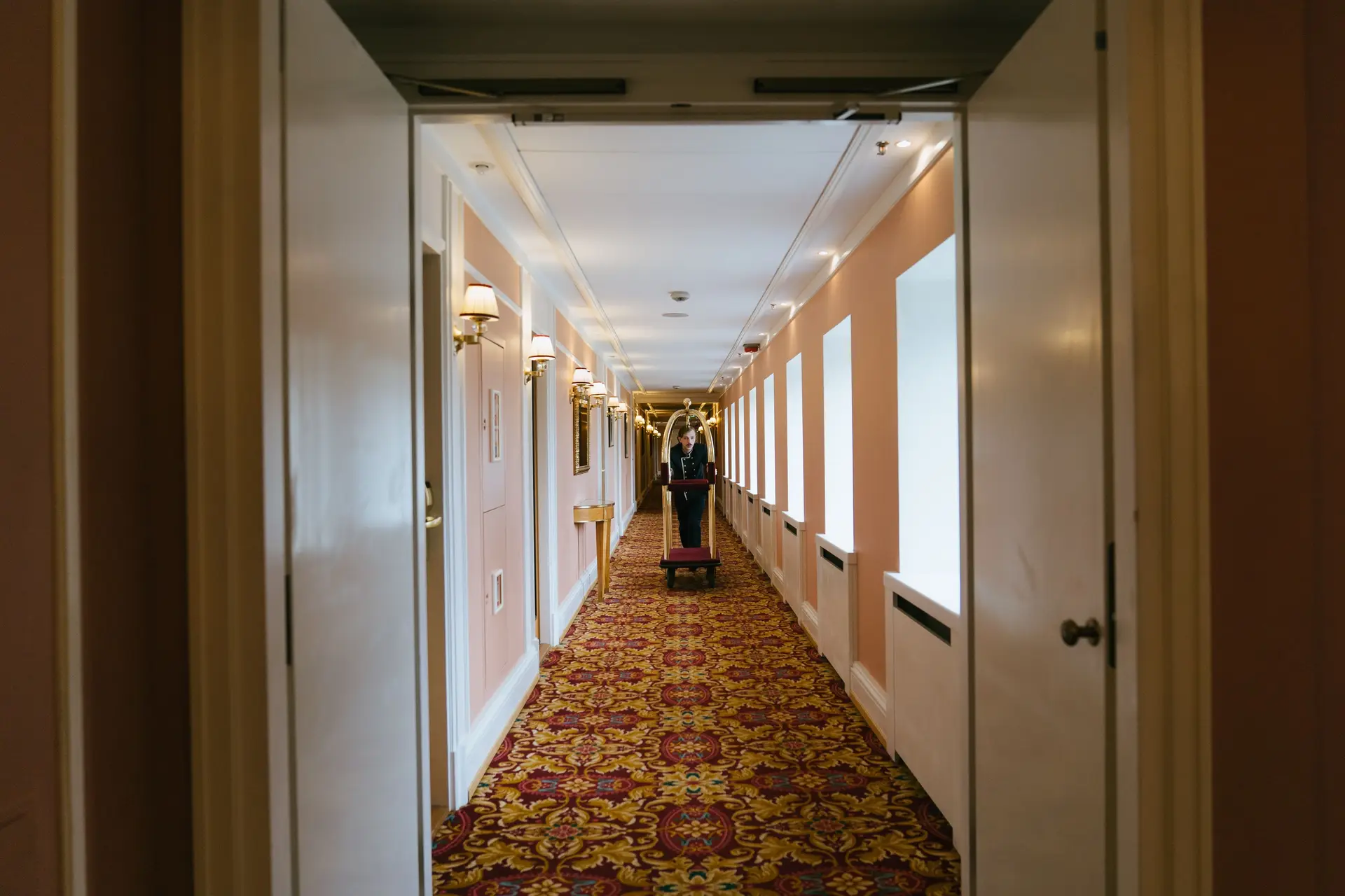 Bellboy in luxurious corridor